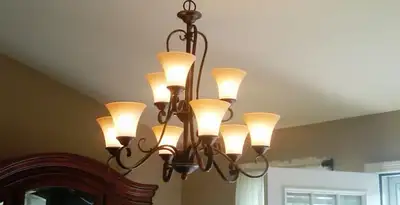 Classic ceiling chandelier installation with warm lighting in Tampa, FL