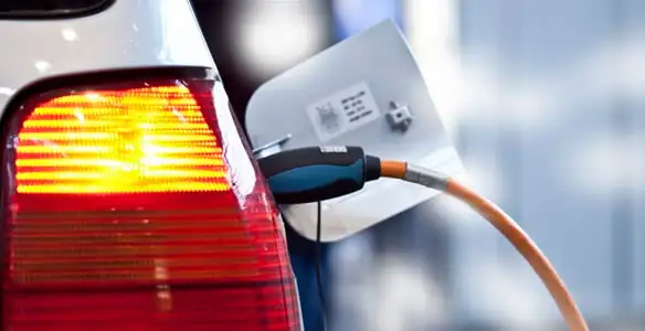Electric car plugged into EV charger after professional installation in Tampa, FL