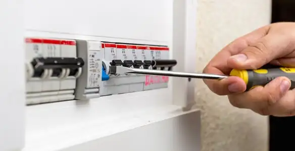 electrical panel upgrade service showing technician adjusting circuit breakers during system upgrade in Tampa, FL