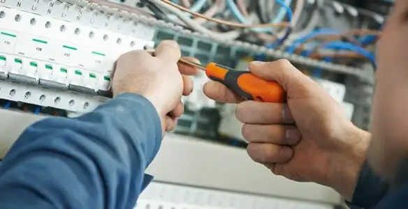 electrical service showing licensed electrician performing electrical panel maintenance and adjustments in Tampa, FL