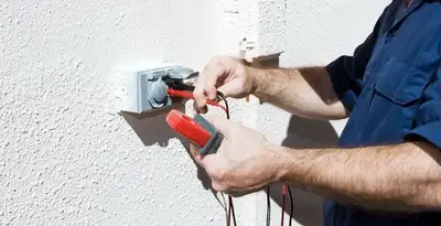 Electrician performing home electrical outlet and wiring inspection in Tampa, FL