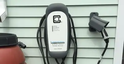 Outdoor electric vehicle charger installation on residential wall in Tampa, FL