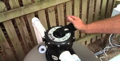 pool pumps service showing professional adjustment of pool pump control system in Tampa, FL