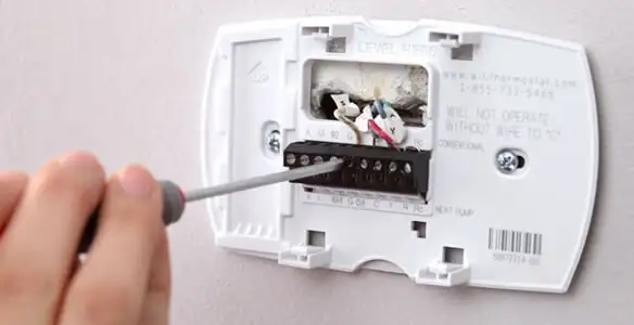 Thermostat installation service with proper wiring and secure wall mounting in Tampa, FL