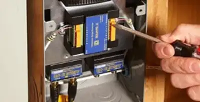 Whole home surge protection device being installed by a licensed electrician to protect electrical systems in Tampa, FL